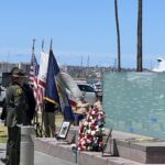 Officers standing in front of memorial wall