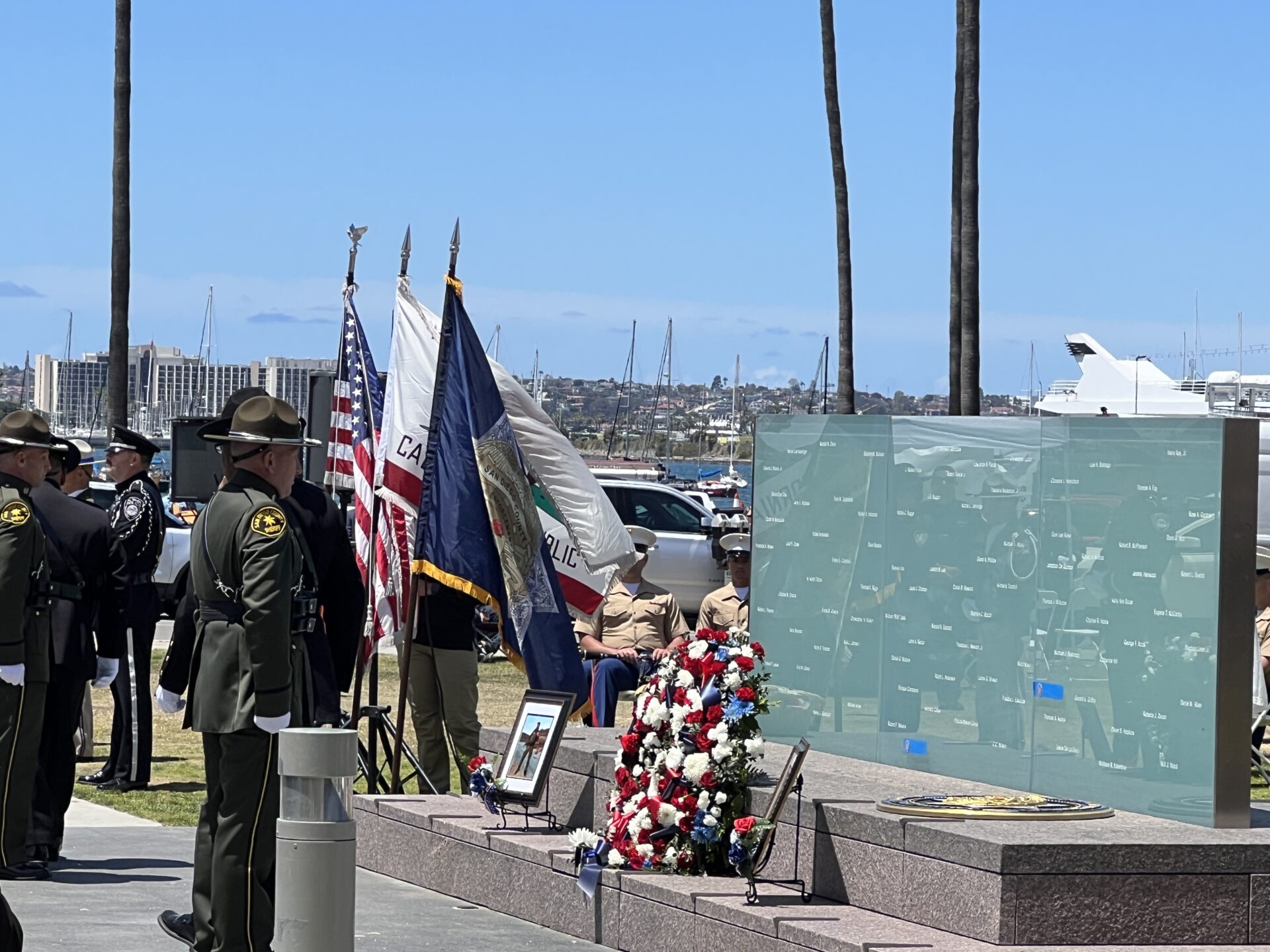 Sheriff standing in front of memorial wall