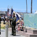 Officer standing in front of memorial wall