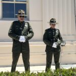 Officers watch memorial ceremony in front of County Administration Center