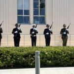 Officers doing 21-gun salute in front of County Administration Center