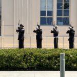 Officers doing 21-gun salute in front of County Administration Center
