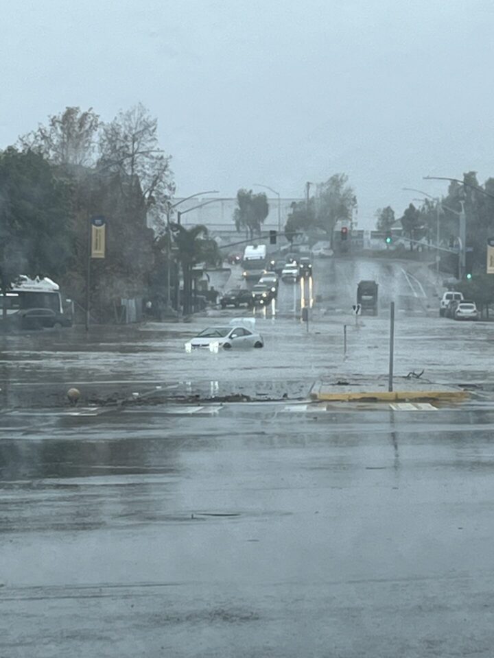 Wide photo showing a view of a flooded County of San Diego street