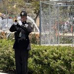 Officer playing trumpet in front of County Administration Center