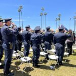 Officers watch memorial ceremony in front of County Administration Center