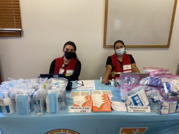 2 representatives from the Medical Care Services division at a table
