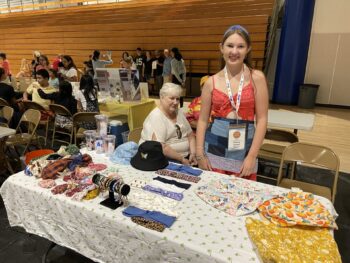 Overview of West Hills High gym with Santee Children's Business Fair tables in place