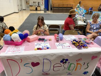 Overview of West Hills High gym with Santee Children's Business Fair tables in place