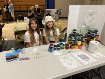 Overview of West Hills High gym with Santee Children's Business Fair tables in place