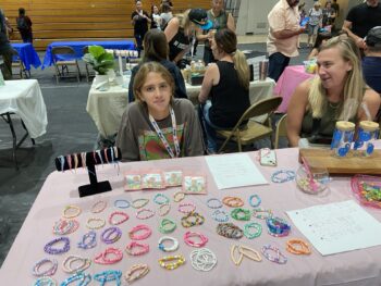 Overview of West Hills High gym with Santee Children's Business Fair tables in place