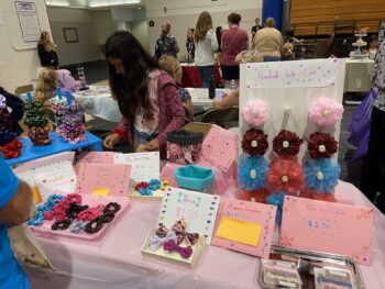 Overview of West Hills High gym with Santee Children's Business Fair tables in place