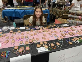 Overview of West Hills High gym with Santee Children's Business Fair tables in place