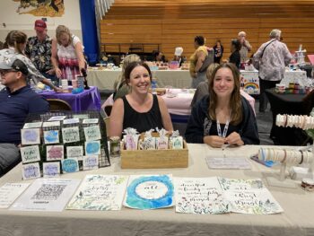 Overview of West Hills High gym with Santee Children's Business Fair tables in place