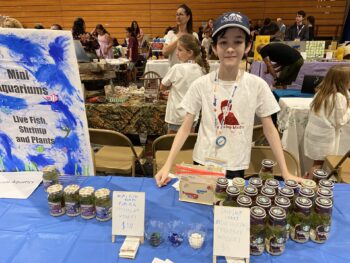 Overview of West Hills High gym with Santee Children's Business Fair tables in place