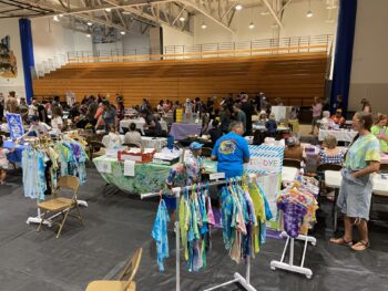Overview of West Hills High gym with Santee Children's Business Fair tables in place
