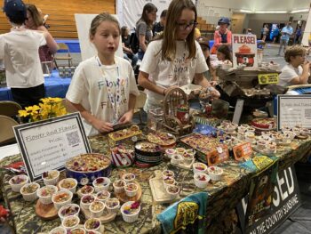 Overview of West Hills High gym with Santee Children's Business Fair tables in place