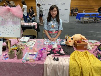 Overview of West Hills High gym with Santee Children's Business Fair tables in place