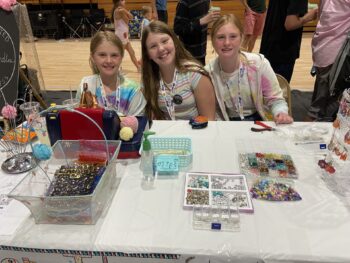 Overview of West Hills High gym with Santee Children's Business Fair tables in place