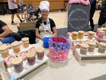 Overview of West Hills High gym with Santee Children's Business Fair tables in place
