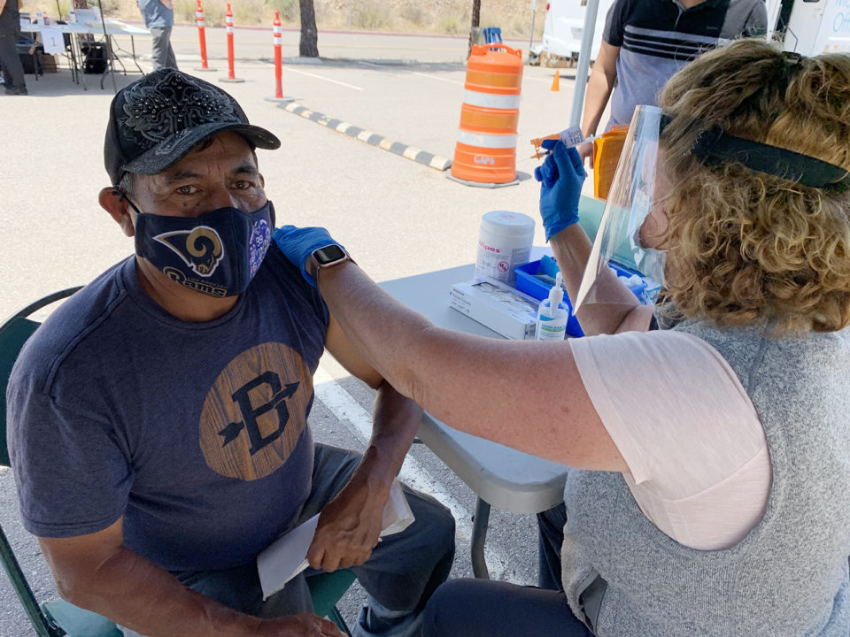 An El Cajon man gets his COVID-19 vaccine at a mobile clinic.