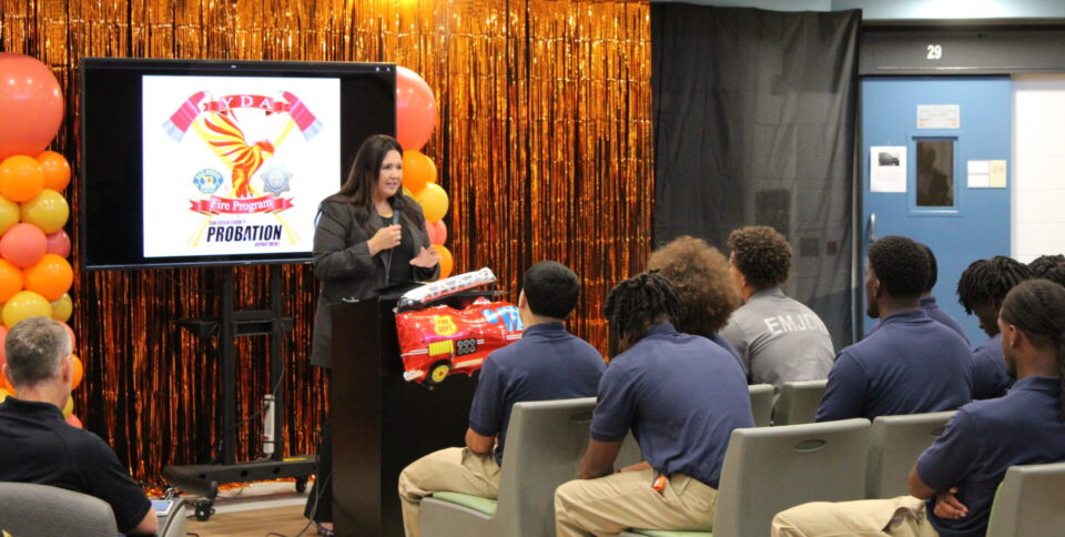 Board of Supervisors Chairwoman Nora Vargas speaking with a gathering of people from a podium about the Fuel Camp