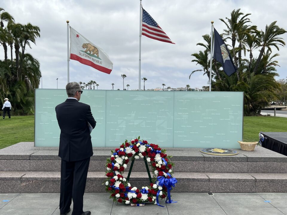 Man standing in front of San Diego Law Enforcement memorial wall.