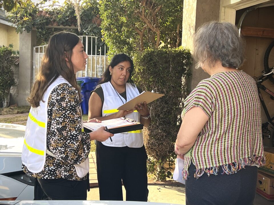 CASPER survey volunteers speak with community member