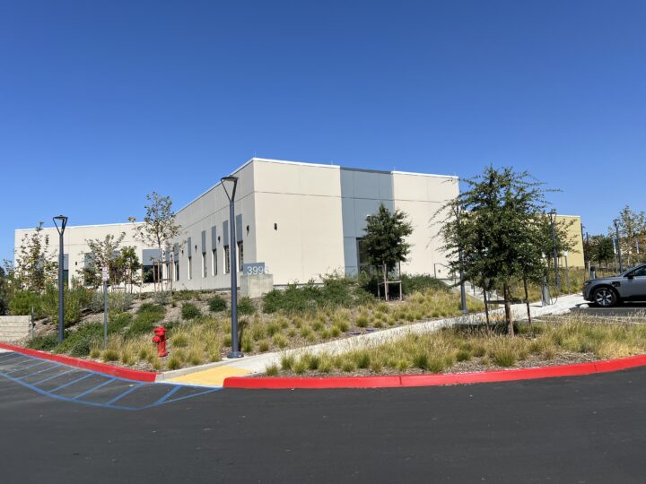 building with cream walls and shrubs