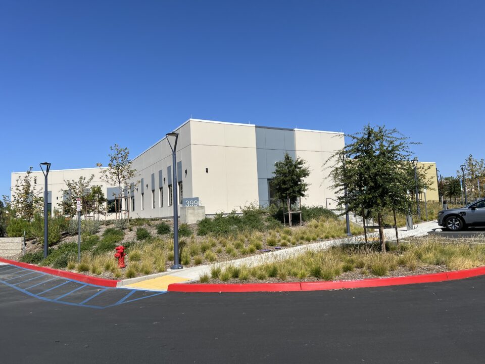 building with cream walls and shrubs