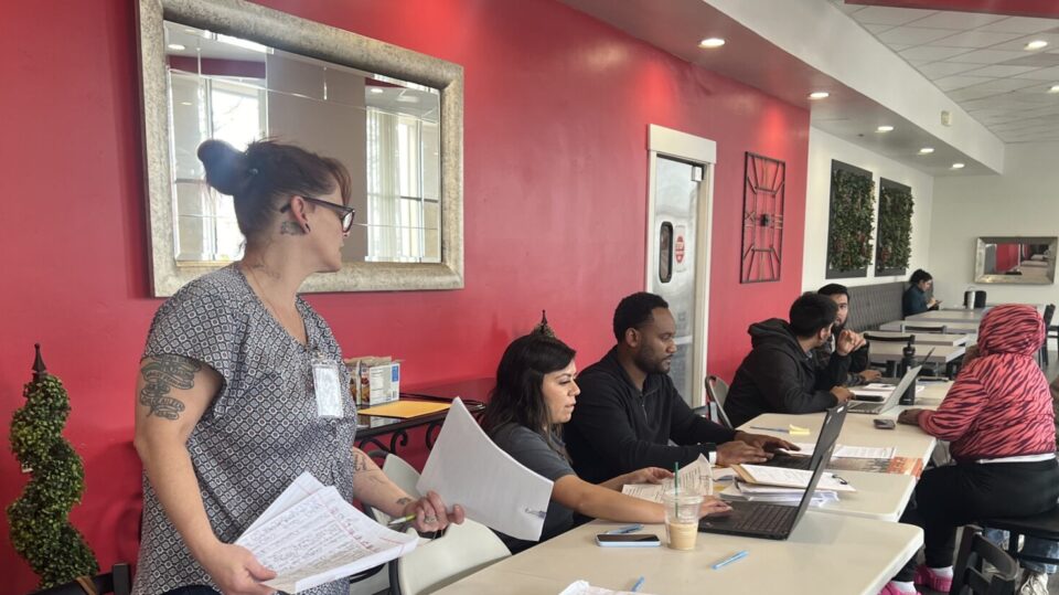 Residents in the Emergency Temporary Lodging Program being helped by County Staff at a hotel.