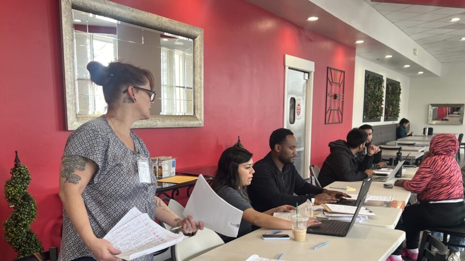 Residents in the Emergency Temporary Lodging Program being helped by County Staff at a hotel.