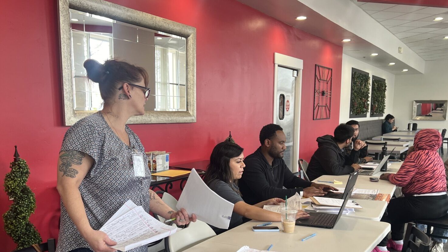 Residents in the Emergency Temporary Lodging Program being helped by County Staff at a hotel.