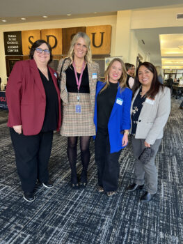 Four professional women standing together
