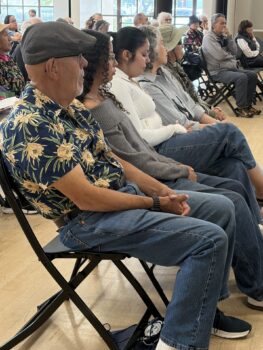 Row of older adults listening to presentation
