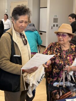 Two senior ladies look over safety information