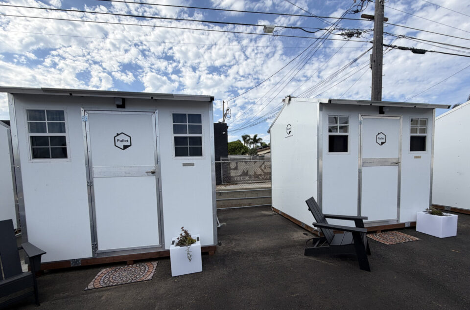 Two tiny home cabins in a parking lot