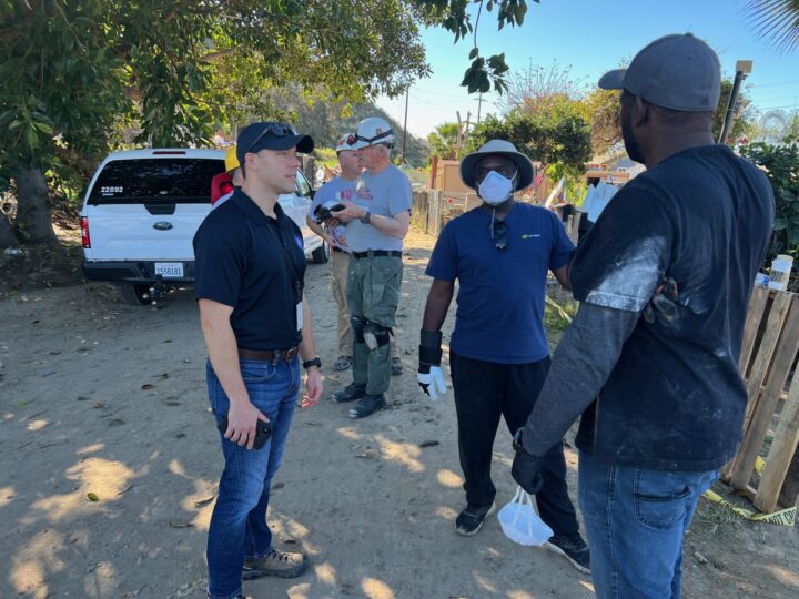 Emergency Services out speaking to flood victims about damage to their neighborhoods