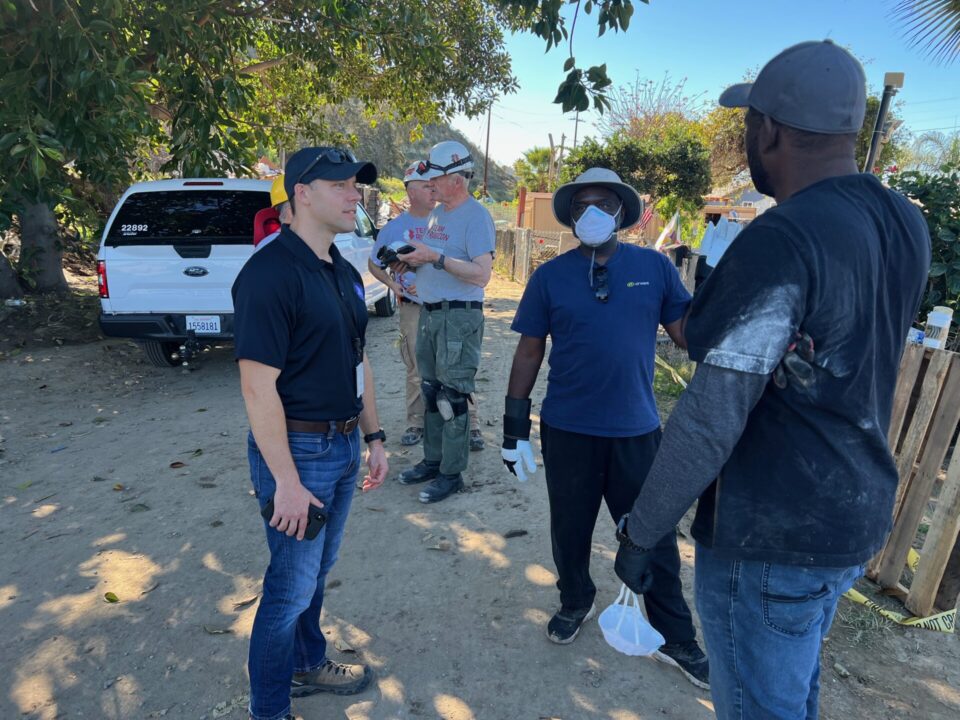 Emergency Services out speaking to flood victims about damage to their neighborhoods