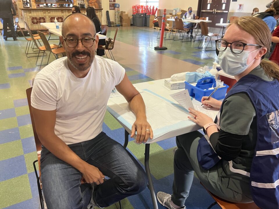 Man waiting for flu shot with nurse
