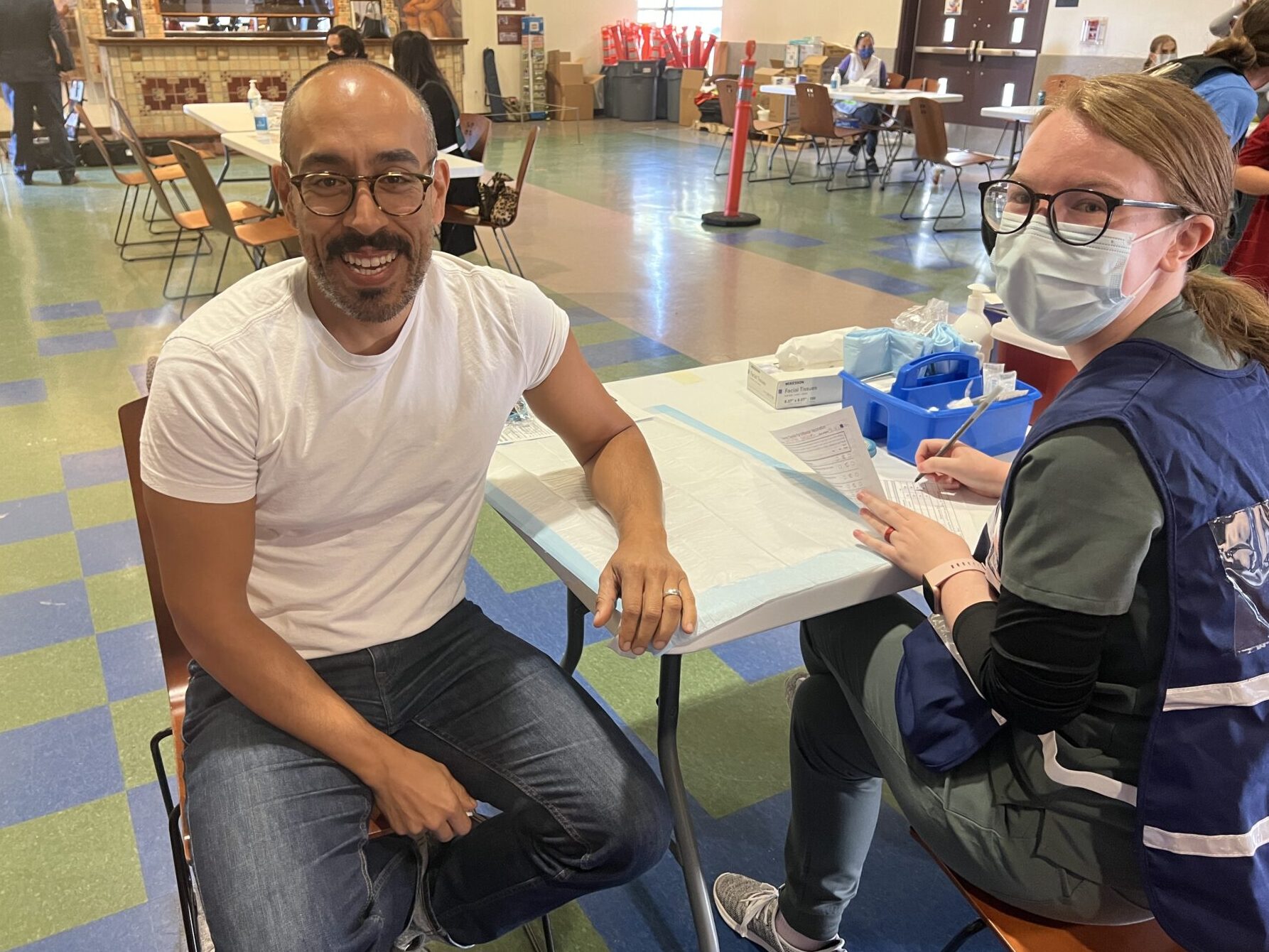 Man waiting for flu shot with nurse