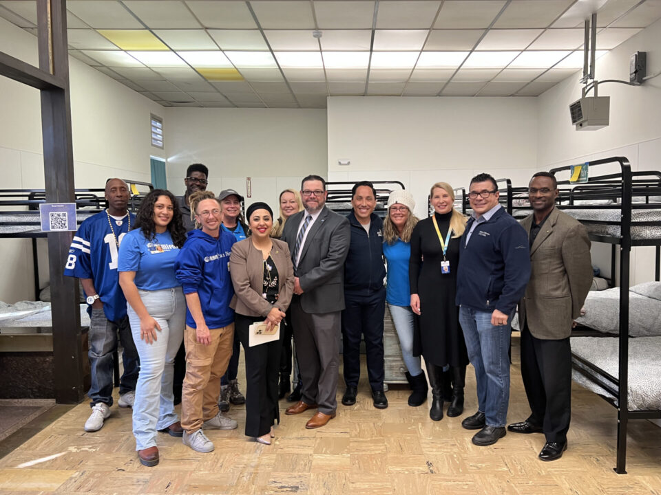 County and City leaders pose at new downtown homeless shelter for women