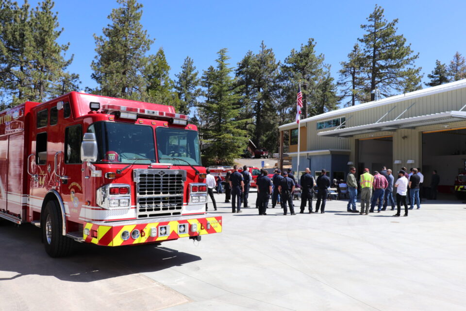 People gathering for the ribbon cutting in front of Mt Laguna fire station 49, with a fire truck in the left foreground