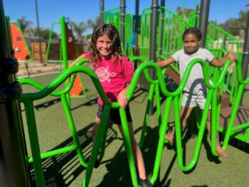 two kids on a playground equipment