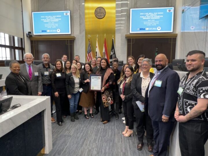 a group stands in the chambers and smiles