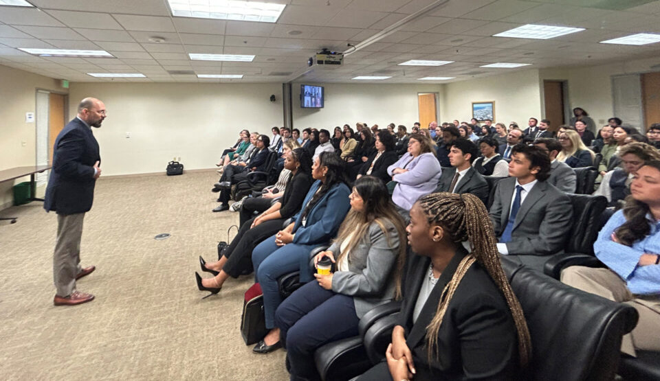 Public defender in front of seated interns