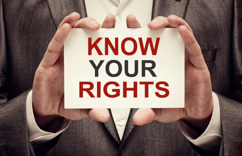 businessman holding sign saying know your rights