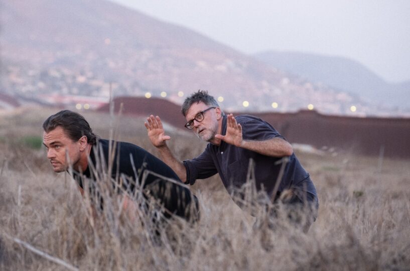 Leo DiCaprio and Paul Thomas Anderson in a field looking into the distance