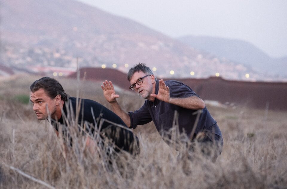 Leo DiCaprio and Paul Thomas Anderson in a field looking into the distance