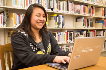 Young woman sitting at a laptop