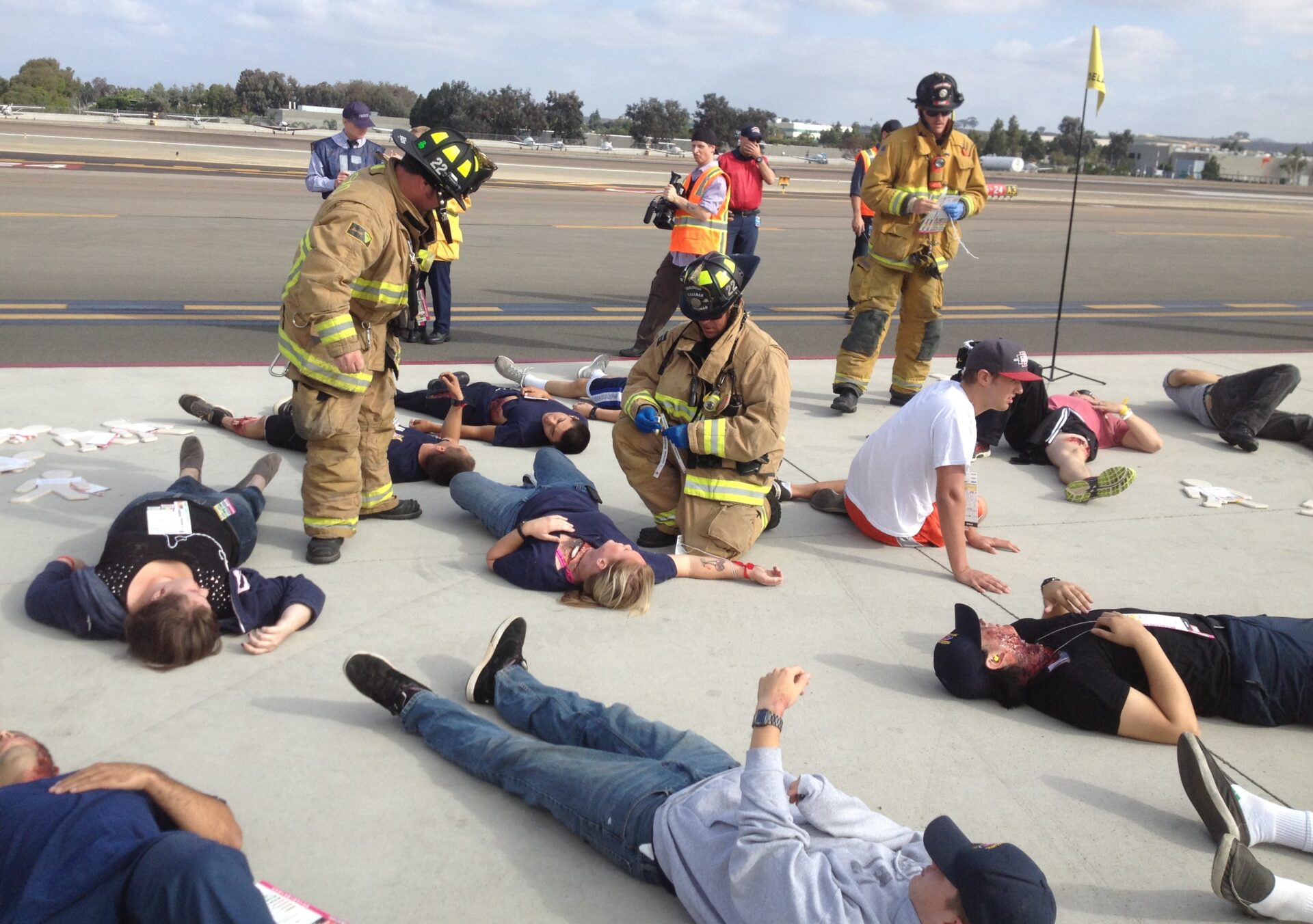 firefighters assistant actors laying on ground